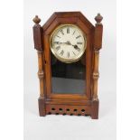 A walnut cased timepiece mantel clock, the case with turned column sides and pierced decoration,