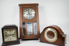 An oak cased wall clock together with two striking mantel clocks