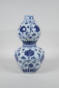 A Chinese Ming style blue and white porcelain double gourd vase with scrolling lotus flower