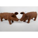 Two cast iron garden figures of pigs, 17" long