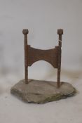 An antique wrought iron bootscraper mounted on a stone base, 16" x 10" x 15"
