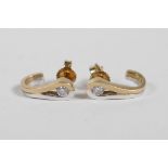 A pair of mixed gold half loop diamond earrings
