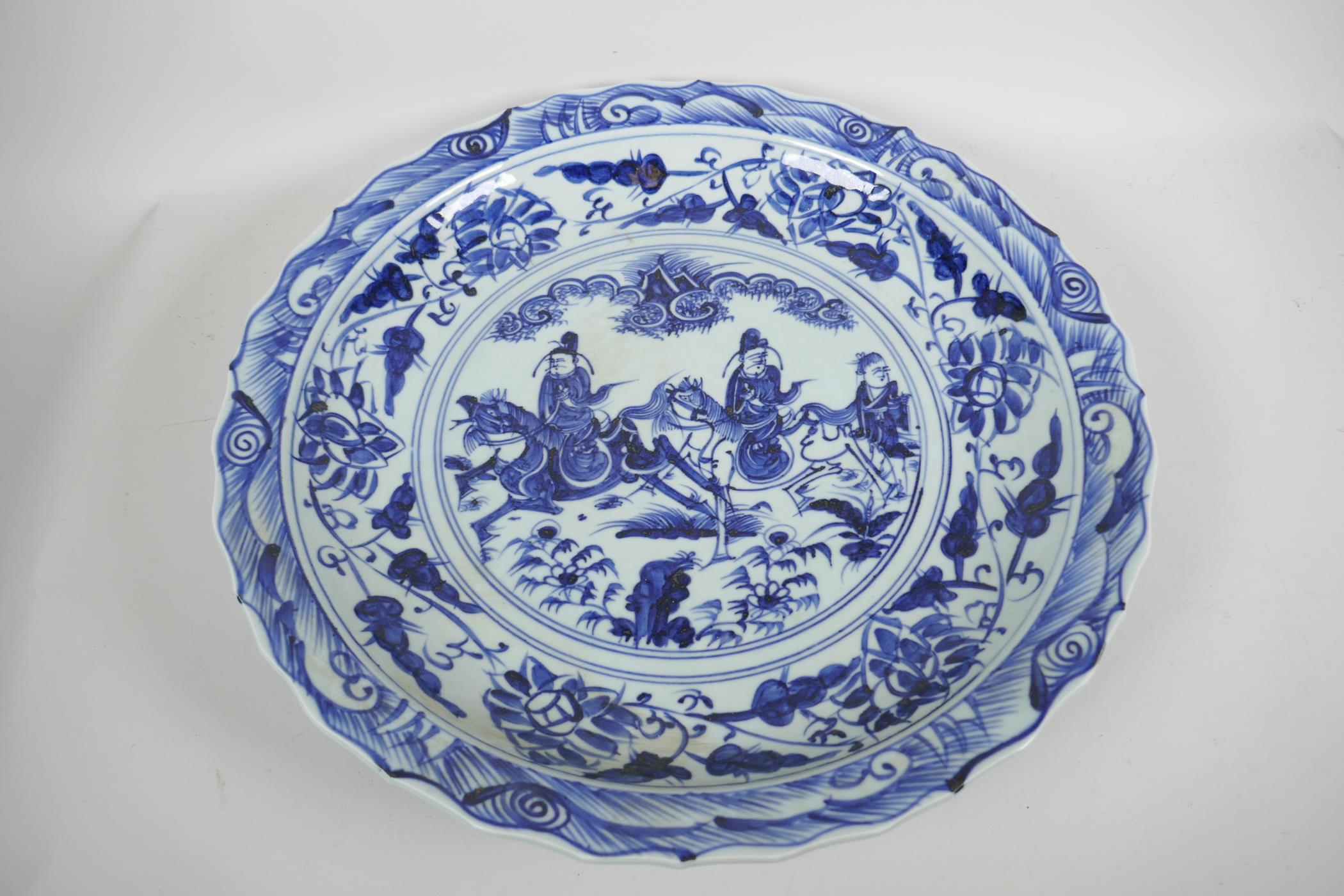 A Chinese blue and white porcelain charger decorated with travellers on horseback, 18½" diameter, - Image 3 of 4
