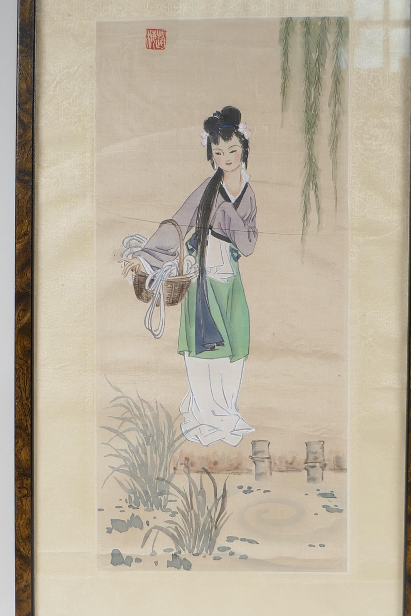 A Chinese painting on silk of a young girl standing by a pond, 8" x 15"