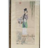 A Chinese painting on silk of a young girl standing by a pond, 8" x 15"