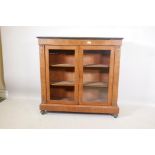 A Victorian walnut two door pier cabinet with boxwood inlay, ebonised edge top and brass mounts,