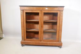 A Victorian walnut two door pier cabinet with boxwood inlay, ebonised edge top and brass mounts,