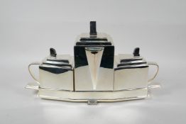 A Christopher Dresser style three piece silver plated tea set, 15½" long