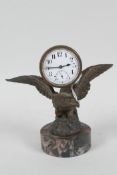 A desk clock cast as an eagle with spread wings, mounted on a marble plinth, 5" high