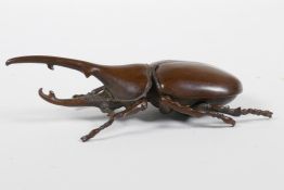 A Japanese Jizai style bronze long horn beetle, the carapace opening to reveal a box, 4½" long