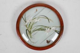 A C19th Chinese framed silk roundel depicting irises and butterflies, the silk viewable from both