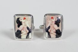 A pair of sterling silver cufflinks set with cold enamel plaques depicting a Vargas style pinup