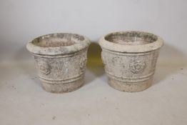 A pair of reconstituted stone garden planters with Tudor Rose decoration, 17" diameter, 12½" high
