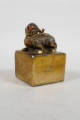 A Chinese gilt filled bronze seal with a kylin knop, 2" x 2"