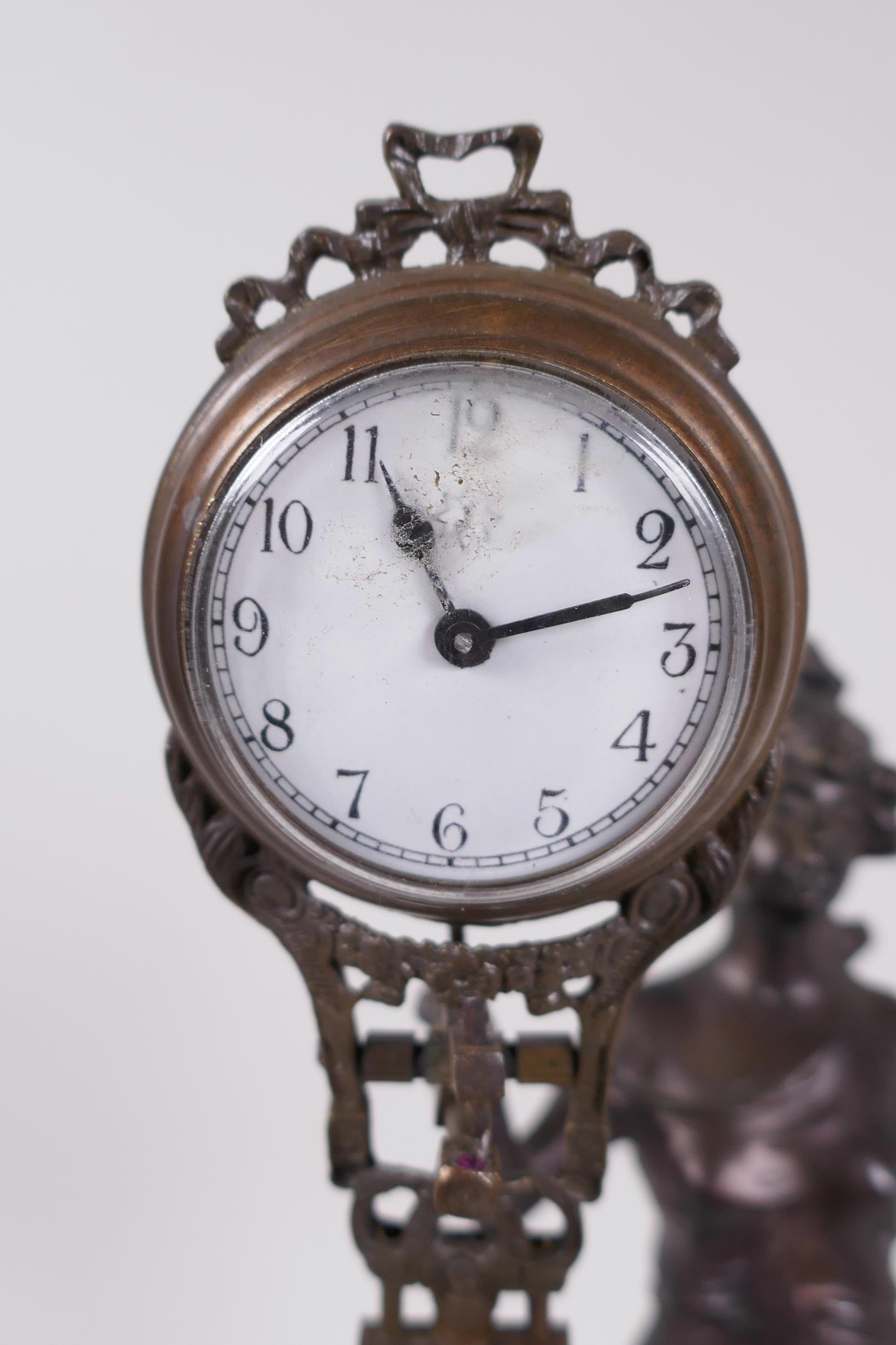 A bronze mystery clock cast as an Art Nouveau style lady with the clock raised on one arm, 13" high - Image 3 of 4