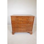 A Georgian mahogany chest of drawers with a brushing slide over four graduated drawers, raised on