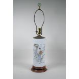 A Chinese famille rose porcelain cylinder vase converted to a lamp with a hardwood base and brass