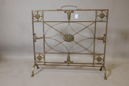 A Victorian brass firescreen, with applied patarae and harebell decoration, 30" x 28"