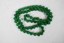 A string of green jade beads, 38" long