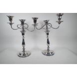 A pair of tall classical style silver plated three light candelabra, 15" high, one A/F