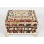 An Oriental bone and tortoiseshell trinket box, with carved and pierced penwork decoration, interior