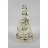 A Chinese blanc de chine porcelain Quan Yin seated on a lotus throne, impressed marks verso, 10½"