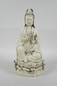 A Chinese blanc de chine porcelain Quan Yin seated on a lotus throne, impressed marks verso, 10½"