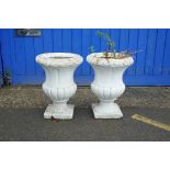 A pair of painted concrete garden urns, 22½" high, 16½" diameter