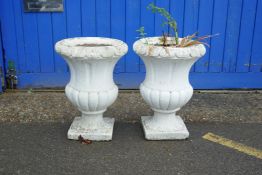 A pair of painted concrete garden urns, 22½" high, 16½" diameter