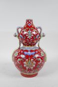 A Chinese polychrome porcelain double gourd vase with two handles and enamelled lotus flower