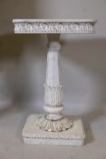 A marble pedestal with carved frieze top, raised on a tapering column with lotus leaf decoration,