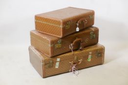 A set of three vintage suitcases, largest 31" x 18½"