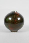 A Japanese enamelled metal globular vase with green and red speckled decoration on a bronze style
