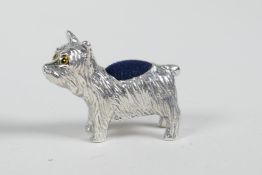 A sterling silver pincushion in the form of a dog, 1" long