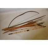 A collection of tribal longbows and spears, most with bamboo shafts and all with wood tips,