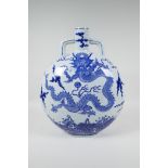 A Chinese blue and white porcelain moon flask decorated with a dragon chasing the flaming pearl,