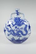 A Chinese blue and white porcelain moon flask decorated with a dragon chasing the flaming pearl,