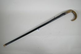 A late C19th/early C20th ebonised walking cane with horn handle and white metal mount, 32" long