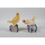 Two carved yellow quartz birds on amethyst bases, 5½" high