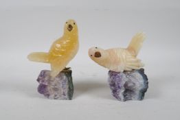 Two carved yellow quartz birds on amethyst bases, 5½" high