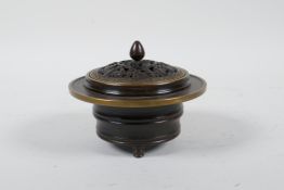 A Chinese bronze censer and cover on tripod feet, the pierced cover with bat and auspicious symbol