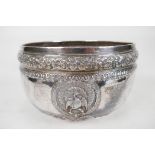 An antique Indian silver bowl, hammered silver with embossed scrolling decoration, a bas relief