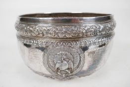 An antique Indian silver bowl, hammered silver with embossed scrolling decoration, a bas relief