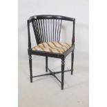 A C19th Aesthetic style ebonised corner chair with slat back, raised on ring turned tapering