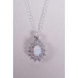 A 925 silver pendant necklace set with an opalite encircled by cubic zirconium, 1" drop