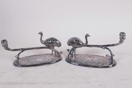 A pair of unusual silver plated knife rests in the form of an ostrich and long branch on a leafy