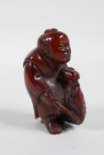 A Chinese carved horn figure of a fisherman, 2½" high