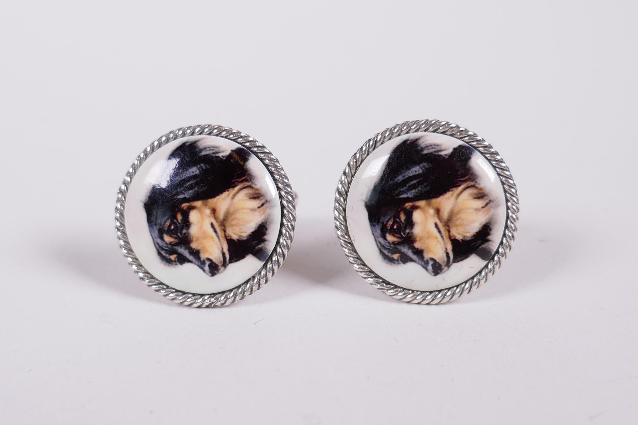 A pair of silver and enamel cufflinks with dog's head decoration