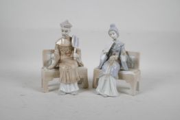 A pair of Lladro style figures of a Chinese man and woman seated on a bench, 7½" high