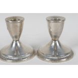 A pair of sterling silver dwarf candlesticks (loaded), 3¼" high